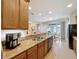 Kitchen bar with stainless sink overlooking breakfast nook and sliding glass doors to the patio at 14655 Potterton Cir, Hudson, FL 34667