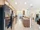 Open-concept kitchen boasts breakfast bar, granite counters, stainless steel appliances, and tile flooring at 14655 Potterton Cir, Hudson, FL 34667