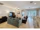 Comfortable living room, with view into a screened-in patio and the kitchen at 14655 Potterton Cir, Hudson, FL 34667