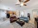 Open-concept living room with ceiling fan, sofas and view into the kitchen at 14655 Potterton Cir, Hudson, FL 34667