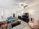 Comfortable living room featuring sofas, TV, and view of front entry at 14655 Potterton Cir, Hudson, FL 34667
