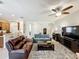 Spacious living room with sofas, TV, and view into the dining area at 14655 Potterton Cir, Hudson, FL 34667