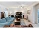 Cozy living room with comfortable seating, ceiling fan, and large screen entertainment center at 14655 Potterton Cir, Hudson, FL 34667