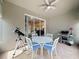 Covered patio with table and chairs and sliding glass door with view to living room at 14655 Potterton Cir, Hudson, FL 34667