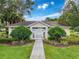 Charming pool house surrounded by well-maintained landscaping and lush green grass at 14655 Potterton Cir, Hudson, FL 34667