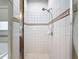 The bathroom has a tiled shower with a hand-held sprayer and decorative tile trim at 14655 Potterton Cir, Hudson, FL 34667