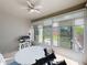 Bright sun room with a ceiling fan, patio furniture, and a view of the well-maintained backyard at 14655 Potterton Cir, Hudson, FL 34667