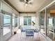 Inviting sun room with tiled floors, patio seating, and sliding door access to the outdoors at 14655 Potterton Cir, Hudson, FL 34667