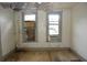 A bedroom with two windows, each featuring an installed air conditioning unit at 1601 Dixie Hwy, Tarpon Springs, FL 34689