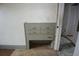 A grey built-in dresser features gold drawer pulls and is located inside a room with a doorway at 1601 Dixie Hwy, Tarpon Springs, FL 34689