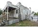 Exterior view of the home showing a covered back porch with lattice and classic architectural details at 1601 Dixie Hwy, Tarpon Springs, FL 34689