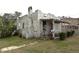 Home exterior featuring a covered porch with lattice details, set in a yard at 1601 Dixie Hwy, Tarpon Springs, FL 34689