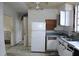Features a refrigerator, cabinets, and a sink, though the area shows signs of disrepair at 1601 Dixie Hwy, Tarpon Springs, FL 34689