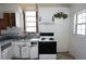 Kitchen features a classic stove, window, sink and vintage cabinets at 1601 Dixie Hwy, Tarpon Springs, FL 34689