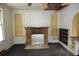 Image showcases a living room with a brick fireplace and vintage cabinets at 1601 Dixie Hwy, Tarpon Springs, FL 34689