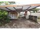 Backyard shed with a corrugated metal awning shows signs of weathering and deterioration at 1601 Dixie Hwy, Tarpon Springs, FL 34689