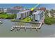 An aerial view of the building shows trees, the waterfront, docks, boats and a view of the beach at 19531 Gulf Blvd # 611, Indian Shores, FL 33785