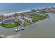 Stunning aerial view of beachfront condos with private boat docks and serene ocean and bay views at 19531 Gulf Blvd # 611, Indian Shores, FL 33785