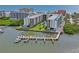An aerial view of the condo complex's marina, pool area, and waterway at 19531 Gulf Blvd # 611, Indian Shores, FL 33785