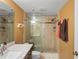 Bathroom with a glass-enclosed shower, neutral tile and a marble countertop vanity at 19531 Gulf Blvd # 611, Indian Shores, FL 33785