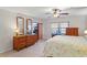 Comfortable bedroom featuring a large window, wood dresser, ceiling fan and access to an outdoor balcony at 19531 Gulf Blvd # 611, Indian Shores, FL 33785