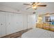 Bedroom with updated floor, ceiling fan, and bright window view next to a large closet at 19531 Gulf Blvd # 611, Indian Shores, FL 33785