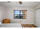 Bedroom with updated floor, ceiling fan, and bright window view with a small dresser at 19531 Gulf Blvd # 611, Indian Shores, FL 33785