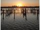 Sunset view of the serene waterfront and dock at 19531 Gulf Blvd # 611, Indian Shores, FL 33785
