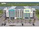 A partial view of the exterior of the building shows a parking lot and trees in front with a waterfront in the background at 19531 Gulf Blvd # 611, Indian Shores, FL 33785