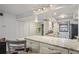 Open concept kitchen features barstool seating, granite countertops, and stainless steel appliances at 19531 Gulf Blvd # 611, Indian Shores, FL 33785