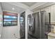 Efficient laundry area with modern washer and dryer next to a stainless steel refrigerator at 19531 Gulf Blvd # 611, Indian Shores, FL 33785
