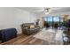 Cozy living room with wood floors and a view of the balcony at 19531 Gulf Blvd # 611, Indian Shores, FL 33785