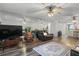 Inviting living room featuring a mirrored wall, ceiling fan, and comfortable seating on wood-look floors at 19531 Gulf Blvd # 611, Indian Shores, FL 33785