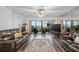 Comfortable living room with a leather sofa and a view of the water from the balcony at 19531 Gulf Blvd # 611, Indian Shores, FL 33785