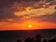 Beautiful sunset view over the ocean, framed by dramatic clouds and silhouetted palm trees at 19531 Gulf Blvd # 611, Indian Shores, FL 33785