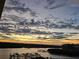 Stunning water view featuring a pier for boats, captured at twilight with dramatic clouds at 19531 Gulf Blvd # 611, Indian Shores, FL 33785