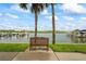 Bench seating faces boat dock in this view of the waterfront property and complex at 19531 Gulf Blvd # 611, Indian Shores, FL 33785
