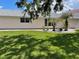 Green backyard with tropical landscaping and white gravel accents, perfect for outdoor enjoyment at 20971 Negril Ct, Lutz, FL 33558