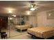 Cozy bedroom showcases mirrored closet doors, ceiling fan, and carpet flooring for a relaxing retreat at 20971 Negril Ct, Lutz, FL 33558