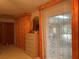 Bedroom with wooden dresser, a large window with curtains, and entry to the bathroom and closet at 20971 Negril Ct, Lutz, FL 33558