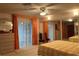Comfortable bedroom features a ceiling fan, natural light, and large closet doors at 20971 Negril Ct, Lutz, FL 33558