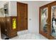 Inviting entryway showcasing an carved wooden door and etched glass french doors leading to bright interior at 20971 Negril Ct, Lutz, FL 33558