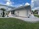 Exterior home view with landscaped yard with decorative rocks, grass, and tropical plants at 20971 Negril Ct, Lutz, FL 33558