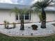 Front of house with palm trees, decorative rock, and prominent address numbers at 20971 Negril Ct, Lutz, FL 33558