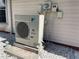 Exterior shot of a Daikin AC unit located next to the home, number 44, on gravel at 20971 Negril Ct, Lutz, FL 33558