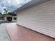 Brick walkway along the side of the home with pristine vinyl siding at 20971 Negril Ct, Lutz, FL 33558