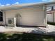 Exterior shot of a Daikin AC unit located next to the home, number 44, on gravel at 20971 Negril Ct, Lutz, FL 33558