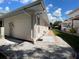 Exterior home showing the side of the house, the utilities, and the yard with gravel at 20971 Negril Ct, Lutz, FL 33558
