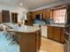 Well-lit kitchen with a tile breakfast bar and oak cabinetry, offering storage and functionality at 20971 Negril Ct, Lutz, FL 33558