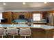 Bright kitchen featuring a functional breakfast bar with tile countertop, and oak cabinetry at 20971 Negril Ct, Lutz, FL 33558